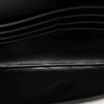 Bottega Veneta leather clutch detail, black intrecciato weave texture