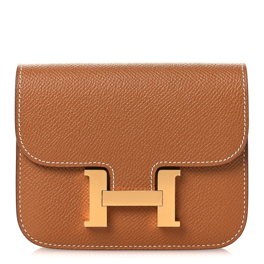 Constance slim wallet in textured tan leather with gold-tone H clasp and flap