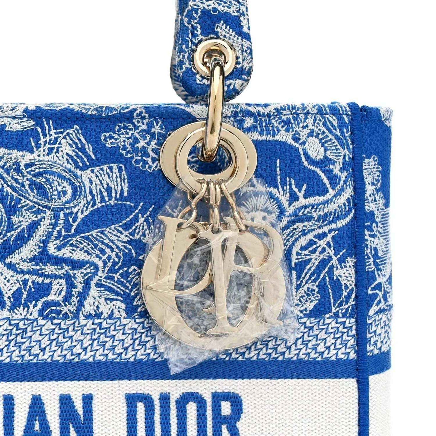 Dior charm with mirrored 'D' monogram on blue and white Toile de Jouy tote