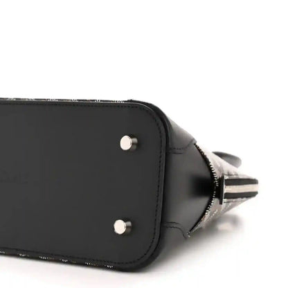 Black mini bag end with silver rivets and zipper closure, plus side seam detail