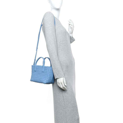 Blue mini cabat tote with woven intrecciato texture and shoulder strap, side view