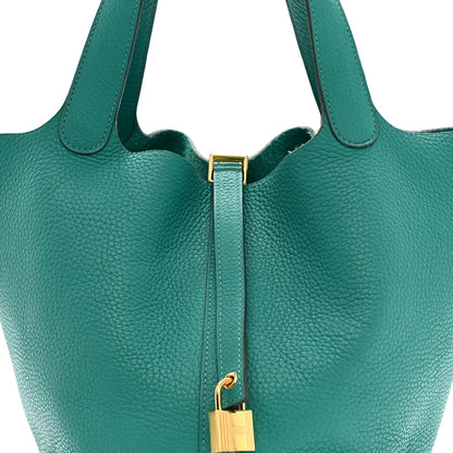 Green leather tote handles with gold-tone lock hardware and strap detail