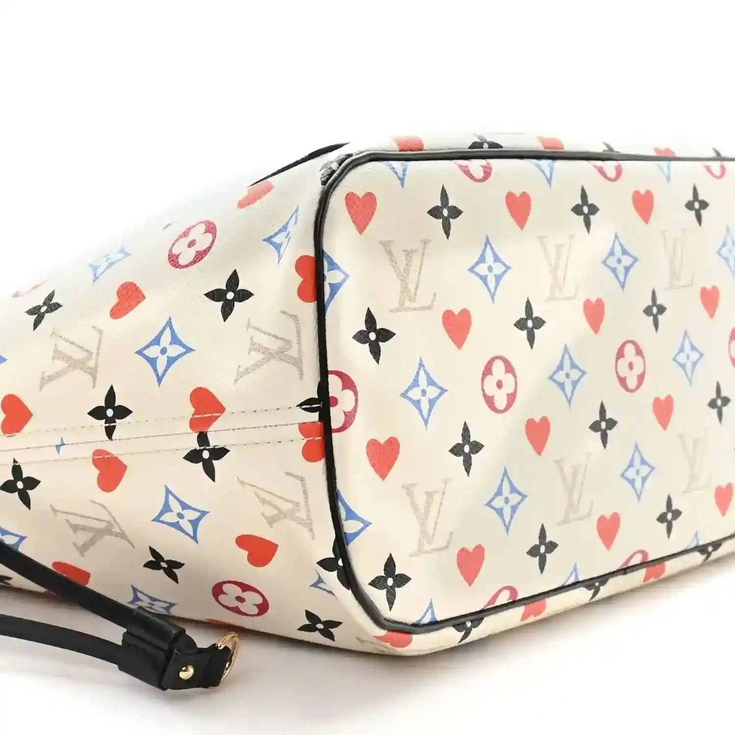 White monogram tote with multicolor heart print, black trim, and zip closure edge