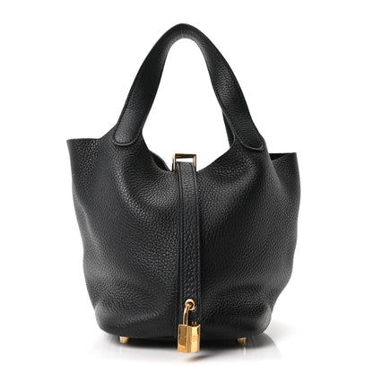 Black pebbled leather tote bag front view with gold zipper pull and secure clasp