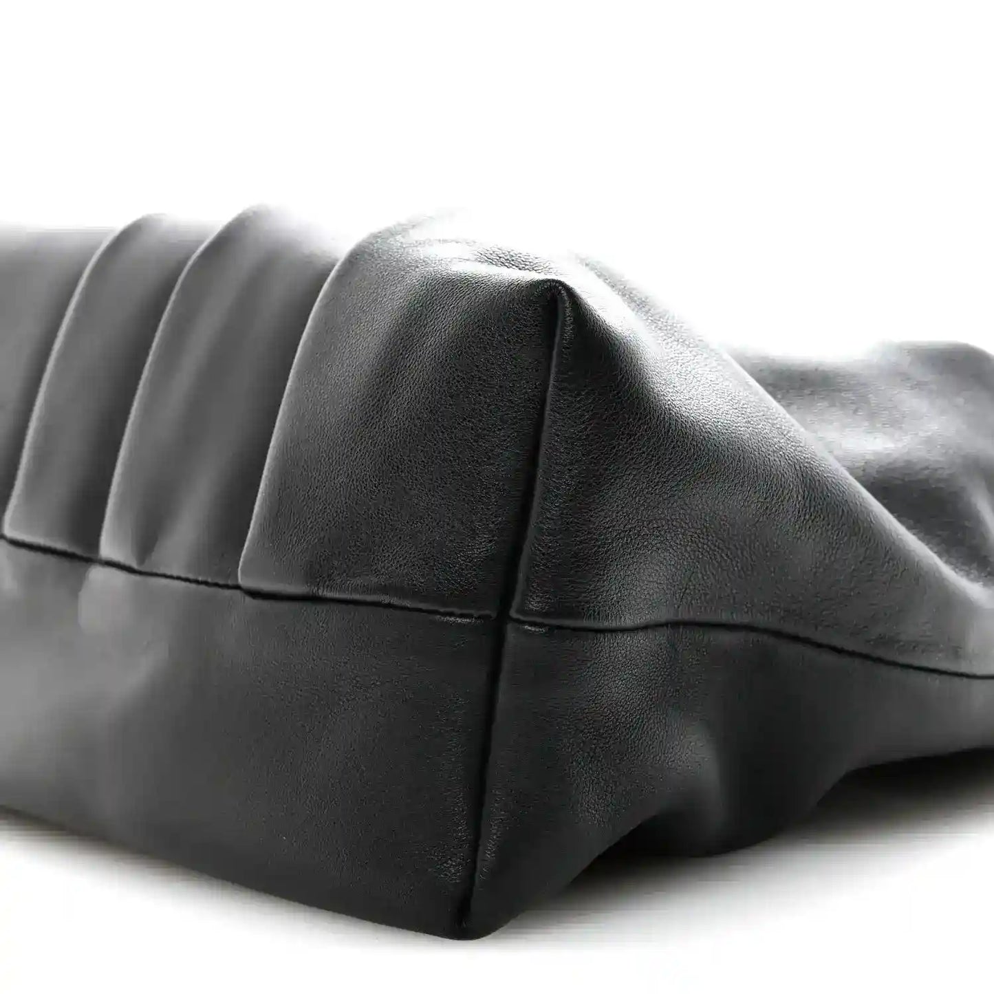 Black leather tote bag with curved side panel and stitched seams