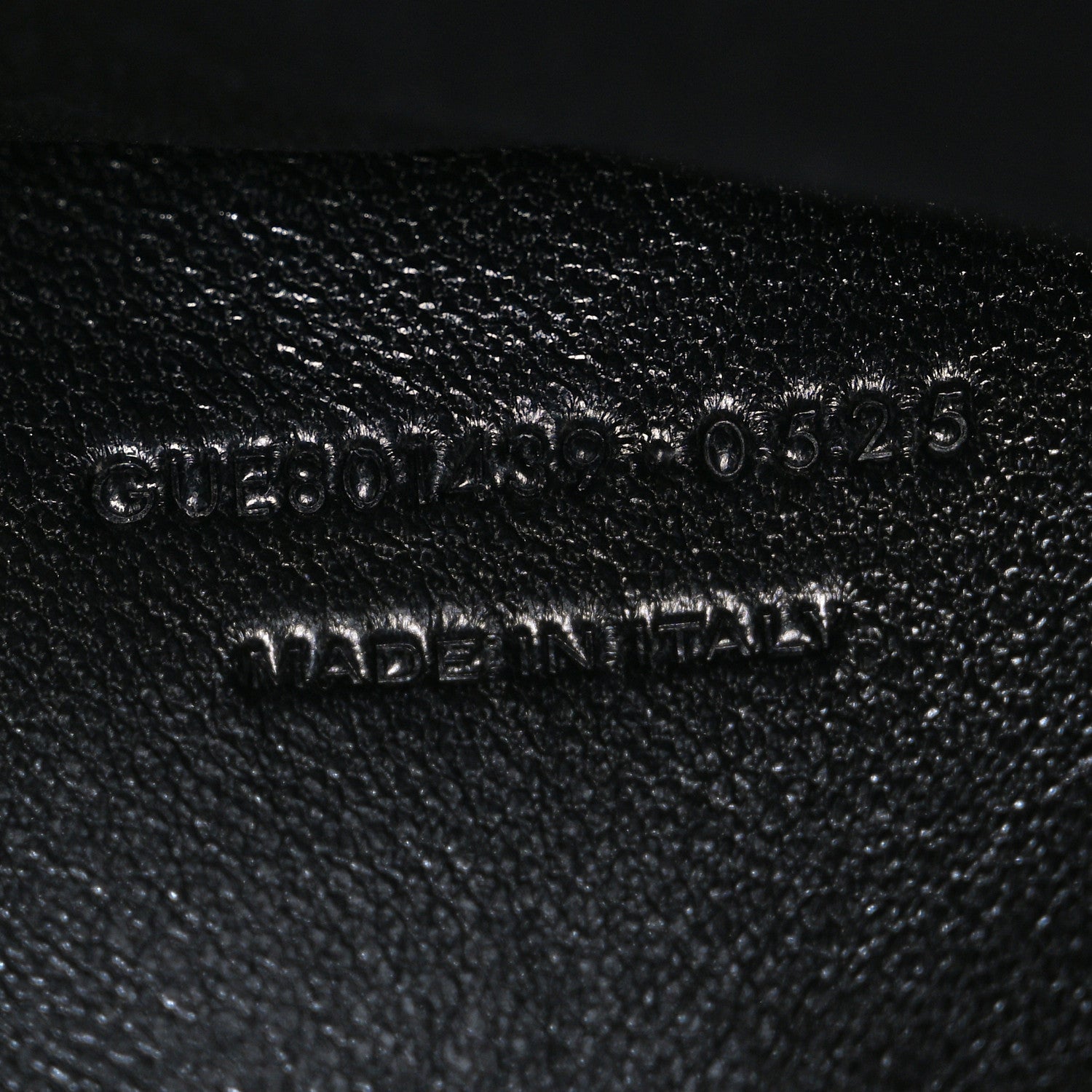 Black leather bag stamp with model code text "0030525" and "MADE IN ITALY"