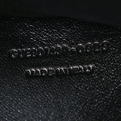 Black leather bag stamp with model code text "0030525" and "MADE IN ITALY"