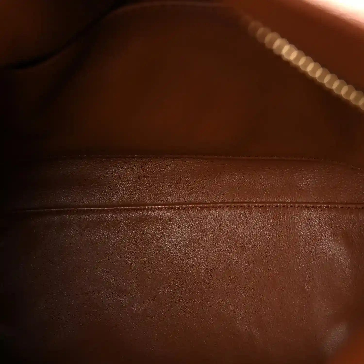 Leather bag interior lining close-up with visible seam stitching