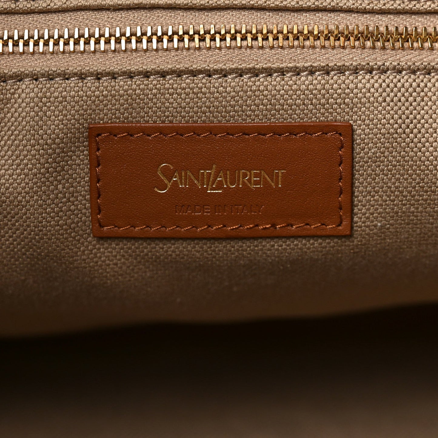 Beige canvas zip area with Saint Laurent logo leather patch
