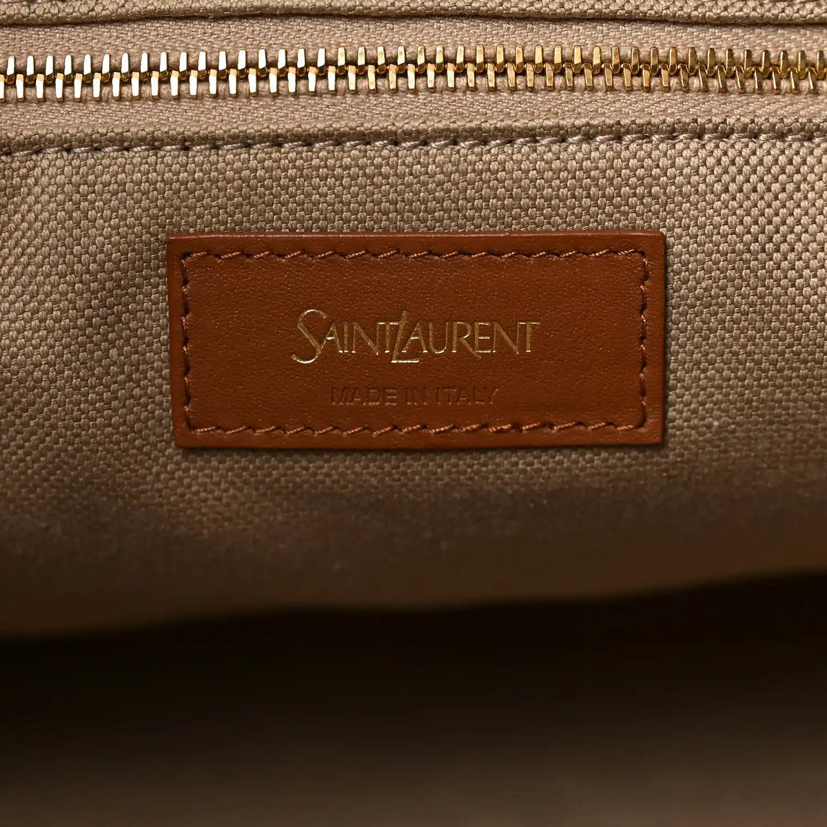 Beige canvas zip area with Saint Laurent logo leather patch