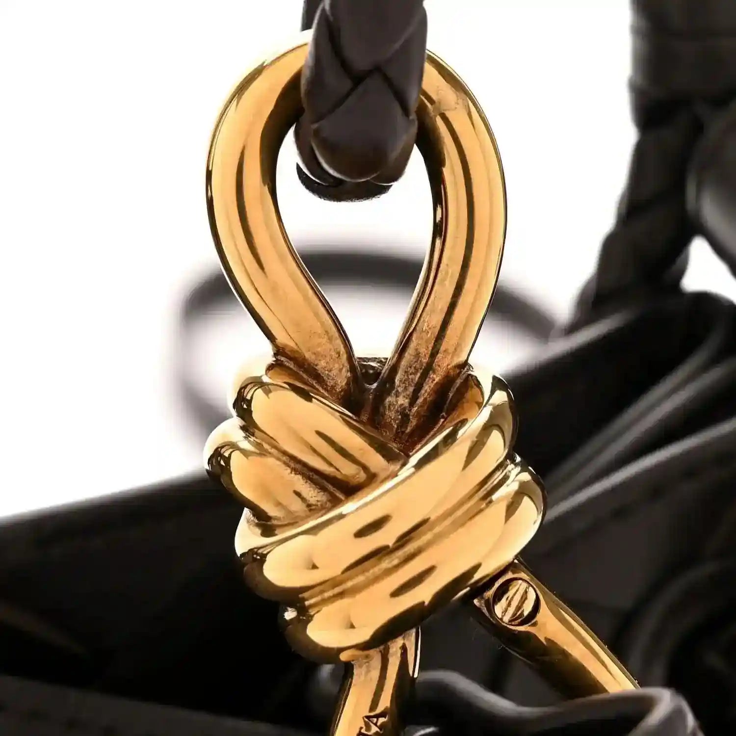 Gold hardware clasp on black intrecciato leather shoulder bag
