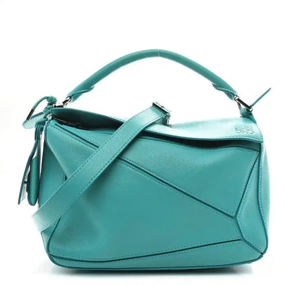 Small Puzzle bag in teal-blue nappa lambskin with top handle and tassel detail.