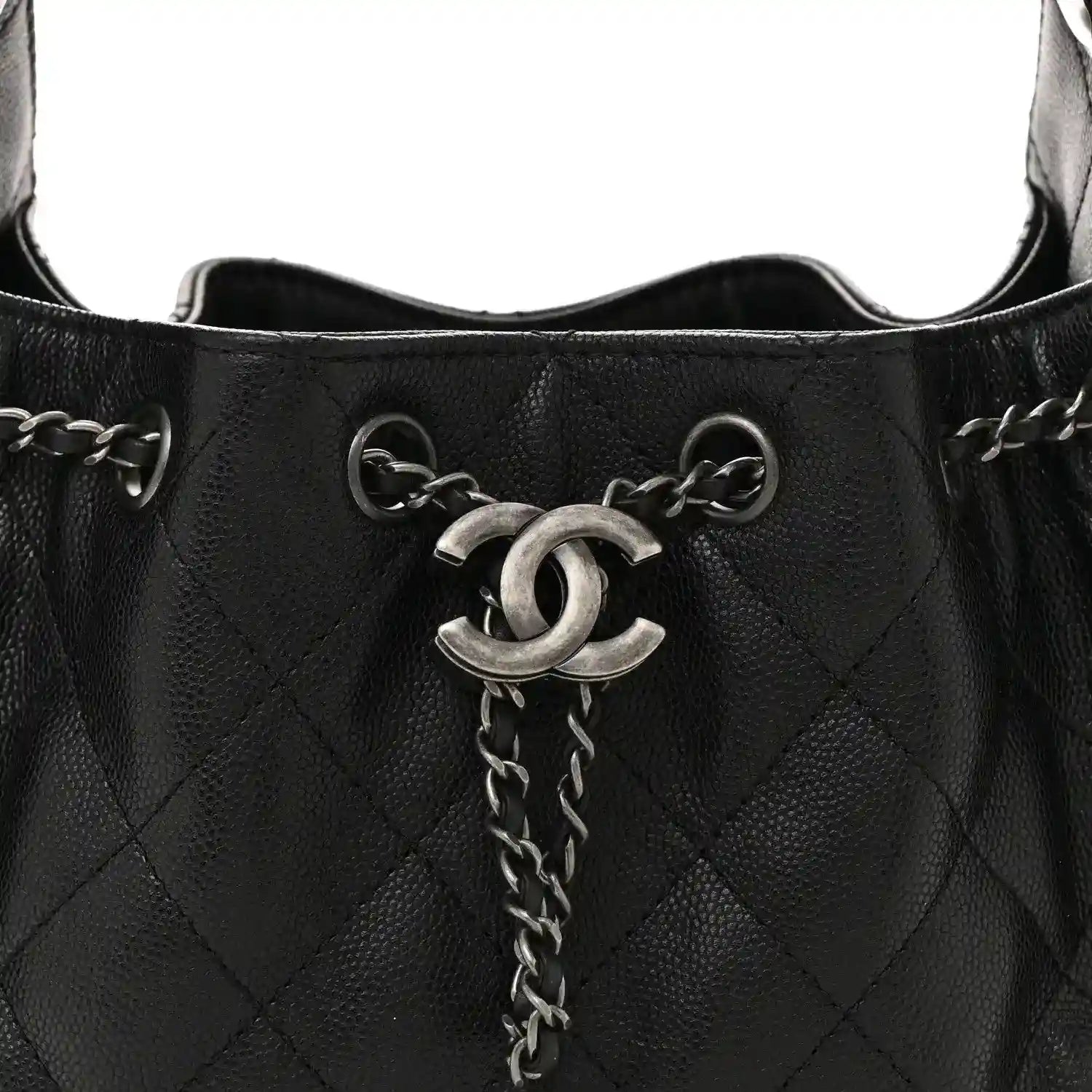 Black quilted mini shoulder bag top opening with CC emblem and chain pull tab.