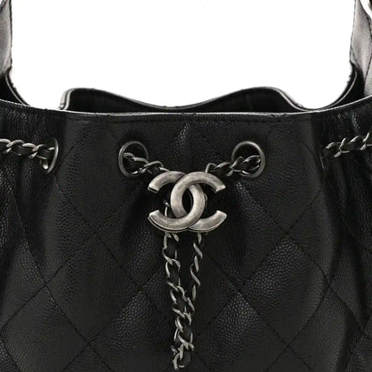 Black quilted mini shoulder bag top opening with CC emblem and chain pull tab.