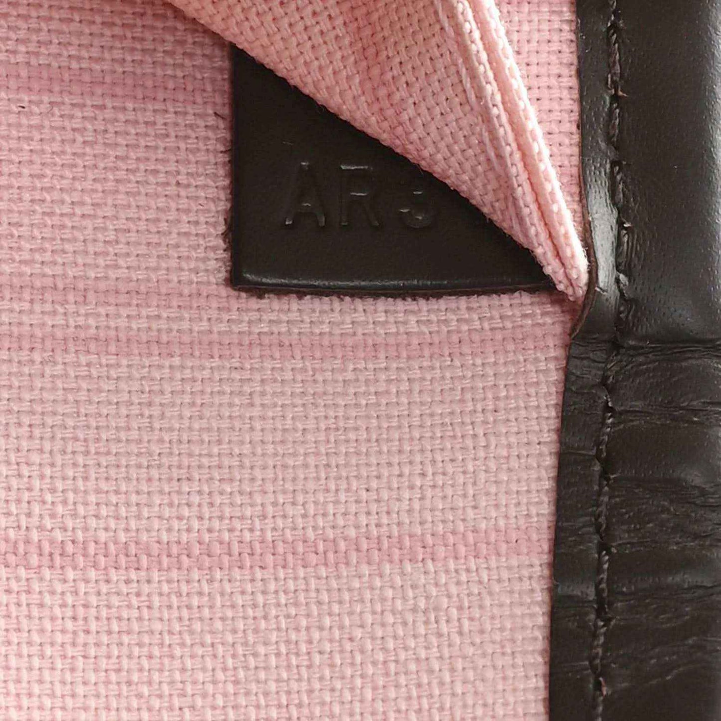 Louis Vuitton tote bag interior patch and stitched leather edge detail