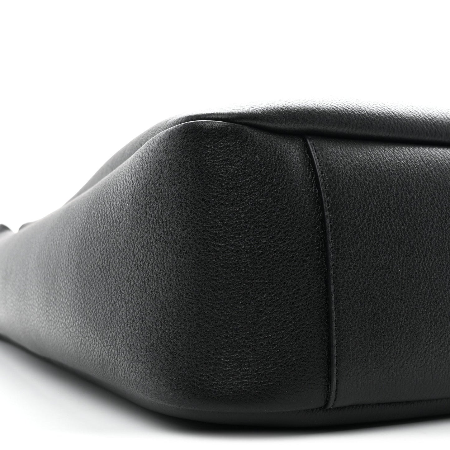 Black calfskin hobo bag close-up, showing curved side panel and smooth grain