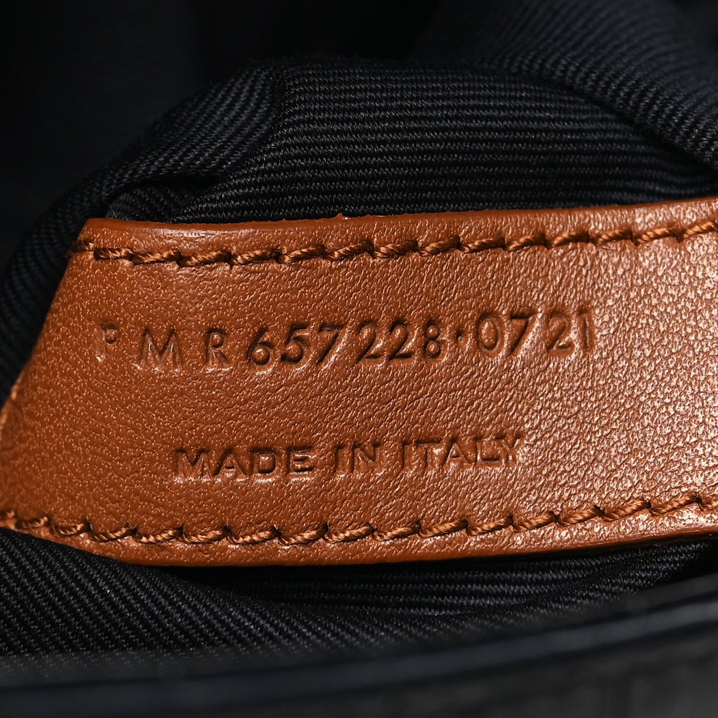 Leather interior stamp reading “MADE IN THE…” with serial code