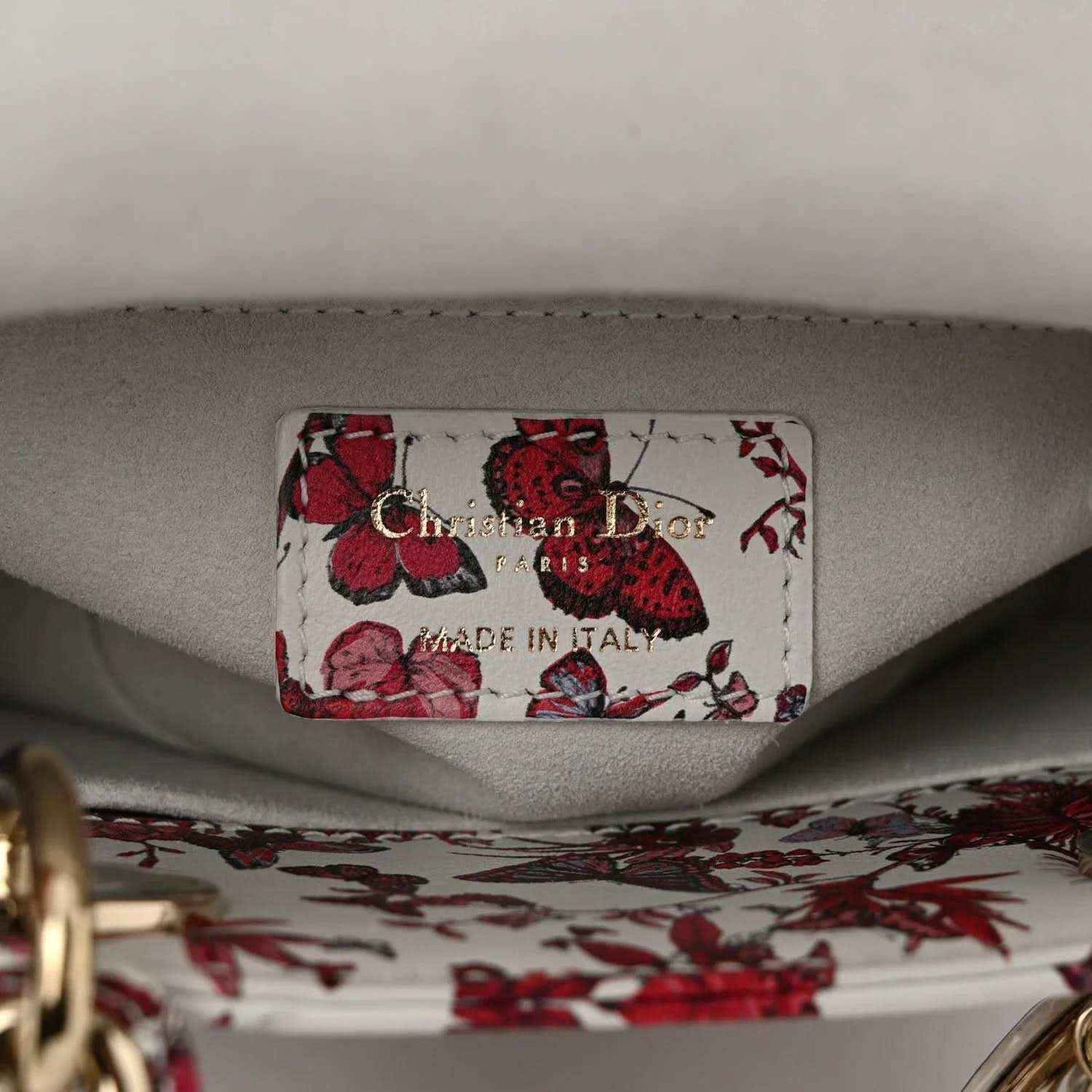 Handbag inner label reading “Christian Dior” and “Made in Italy” on light lining
