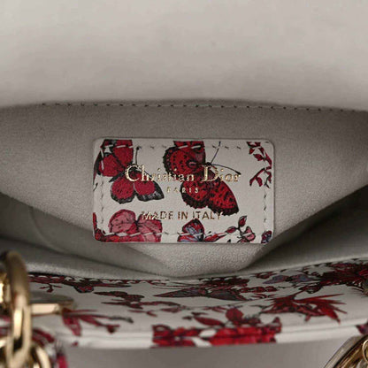 Handbag inner label reading “Christian Dior” and “Made in Italy” on light lining