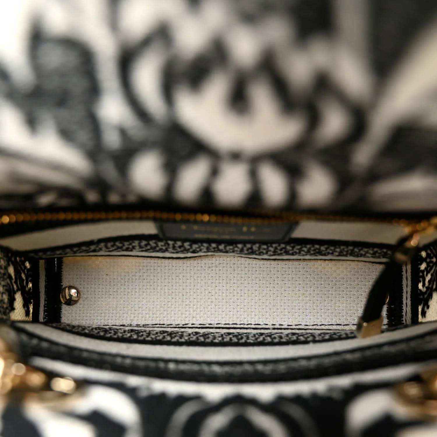 Mini canvas bag interior lining with stitched edge and patterned border near zipper opening