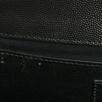 Quilted satchel leather detail with black textured finish and stitched edge