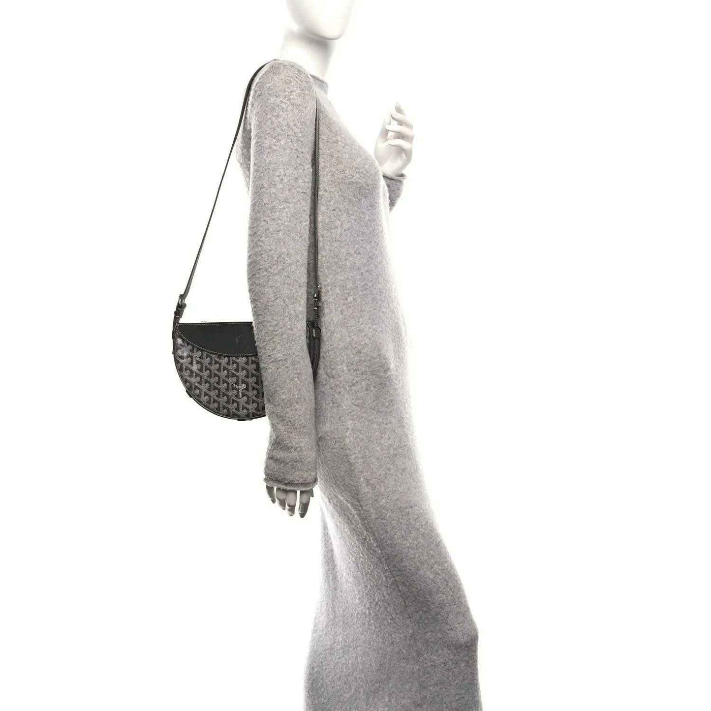 Grey canvas shoulder bag with leather side panel, strap, and metal rings