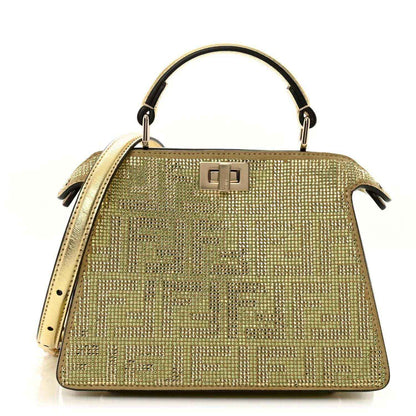 Gold crystal Peekaboo-style satchel with top handle, front clasp, and side tassels