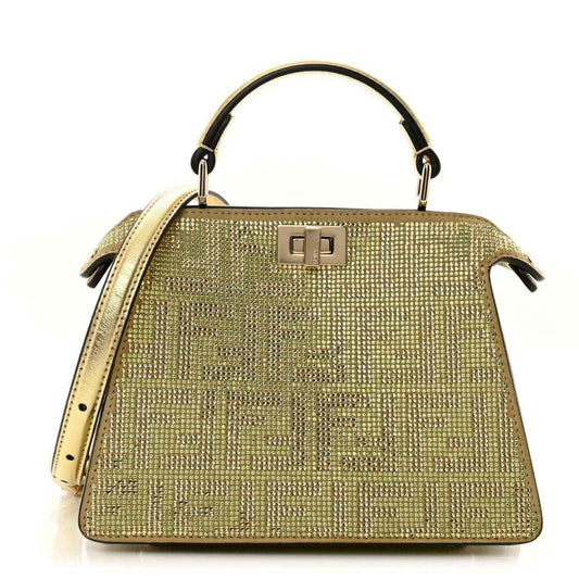 Gold crystal Peekaboo-style satchel with top handle, front clasp, and side tassels