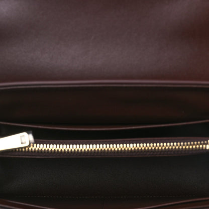Leather bag interior view with gold zipper and dark lining pocket.