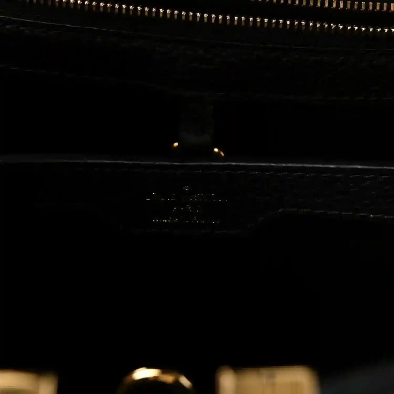 Louis Vuitton Capucines BB bag close-up of black leather with zipper and gold trim