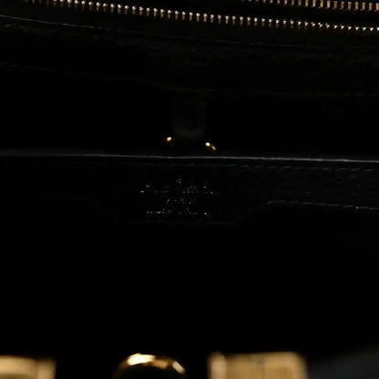 Louis Vuitton Capucines BB bag close-up of black leather with zipper and gold trim