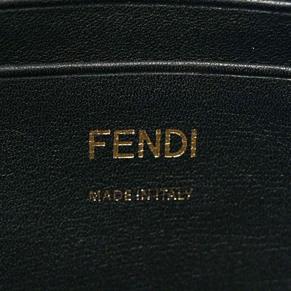 Black leather patch with FENDI lettering, close-up on mini baguette bag.