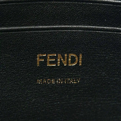 Black leather patch with FENDI lettering, close-up on mini baguette bag.