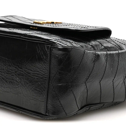 Black quilted leather tote closeup with textured crinkled finish
