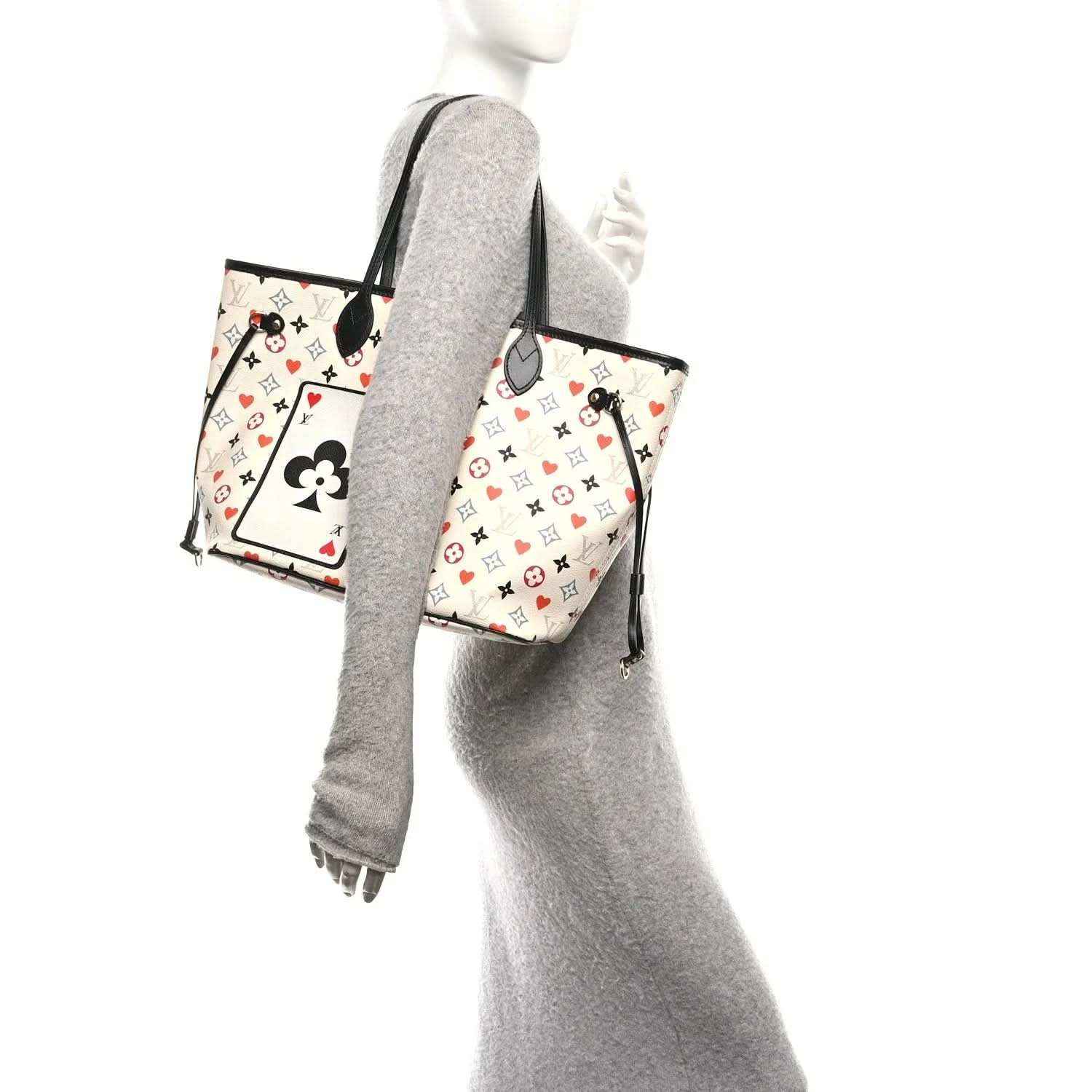 White monogram tote bag with black handles and hanging black strap detail