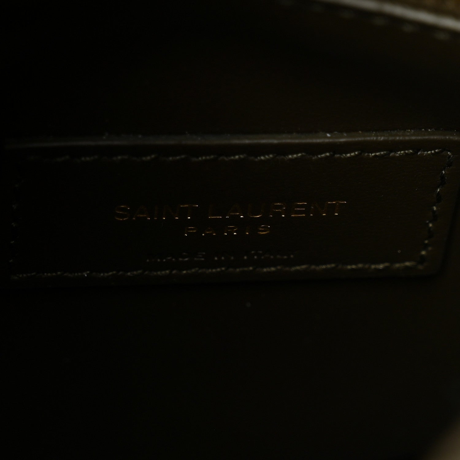 Stitched Saint Laurent logo on leather front panel with contrast trim.