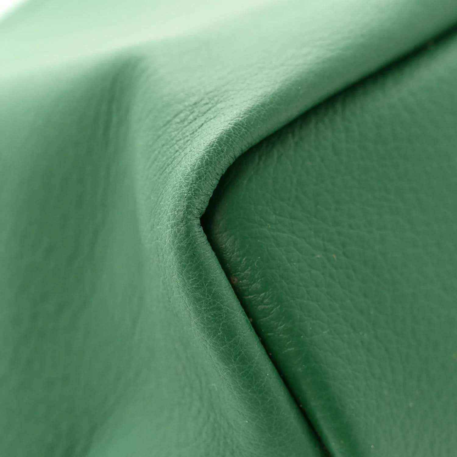 Reversible mini tote bag close-up of green leather-like surface