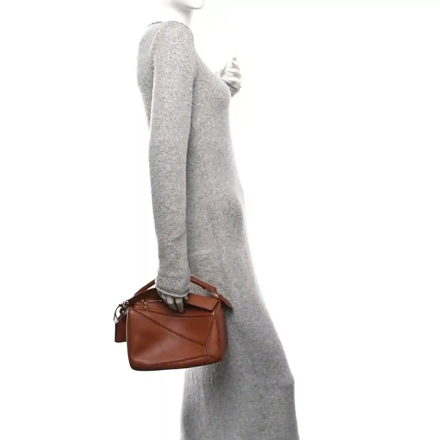 Small Puzzle bag in pecan brown leather, worn with top handle and short strap
