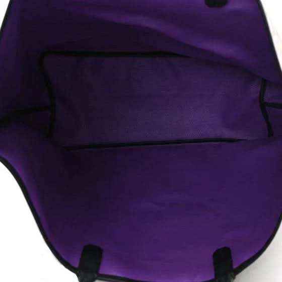 Tote bag interior lining with purple fabric and dark trim, visible top edge