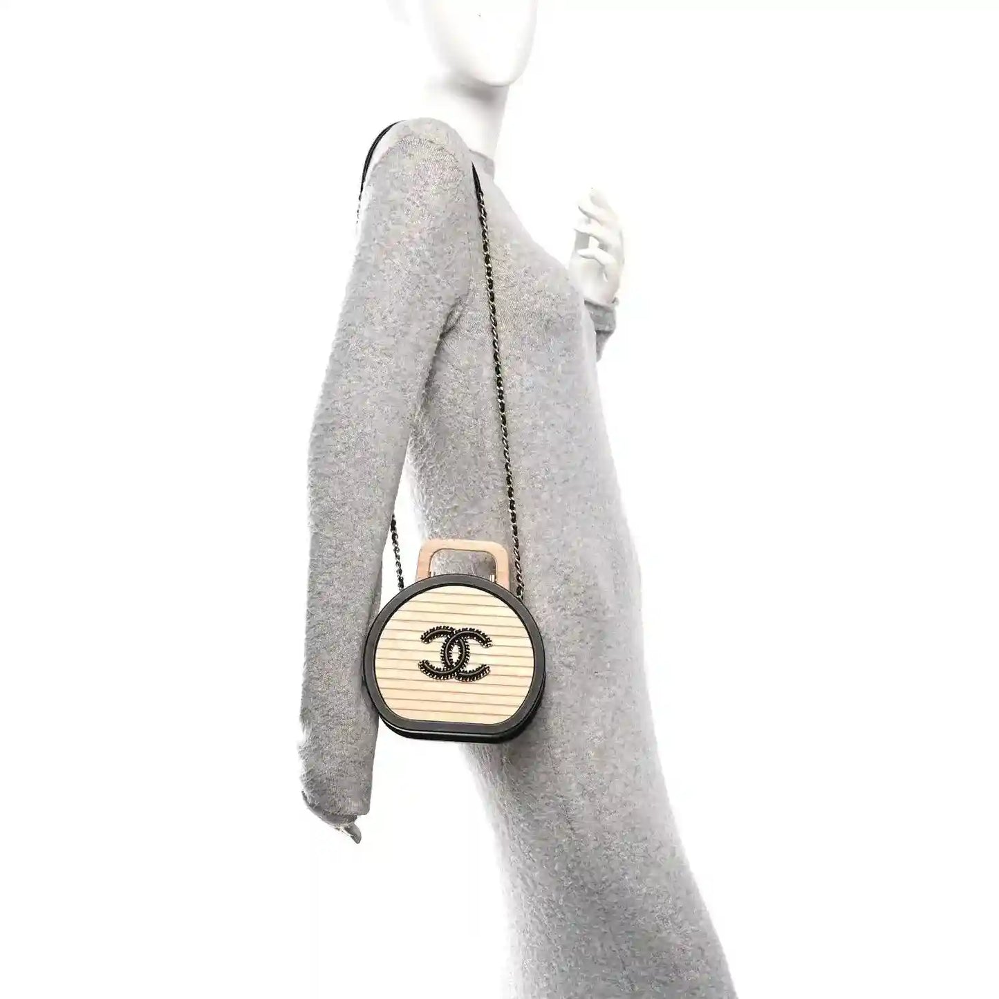 Chanel vanity case side view with chain strap and round CC logo on light panel