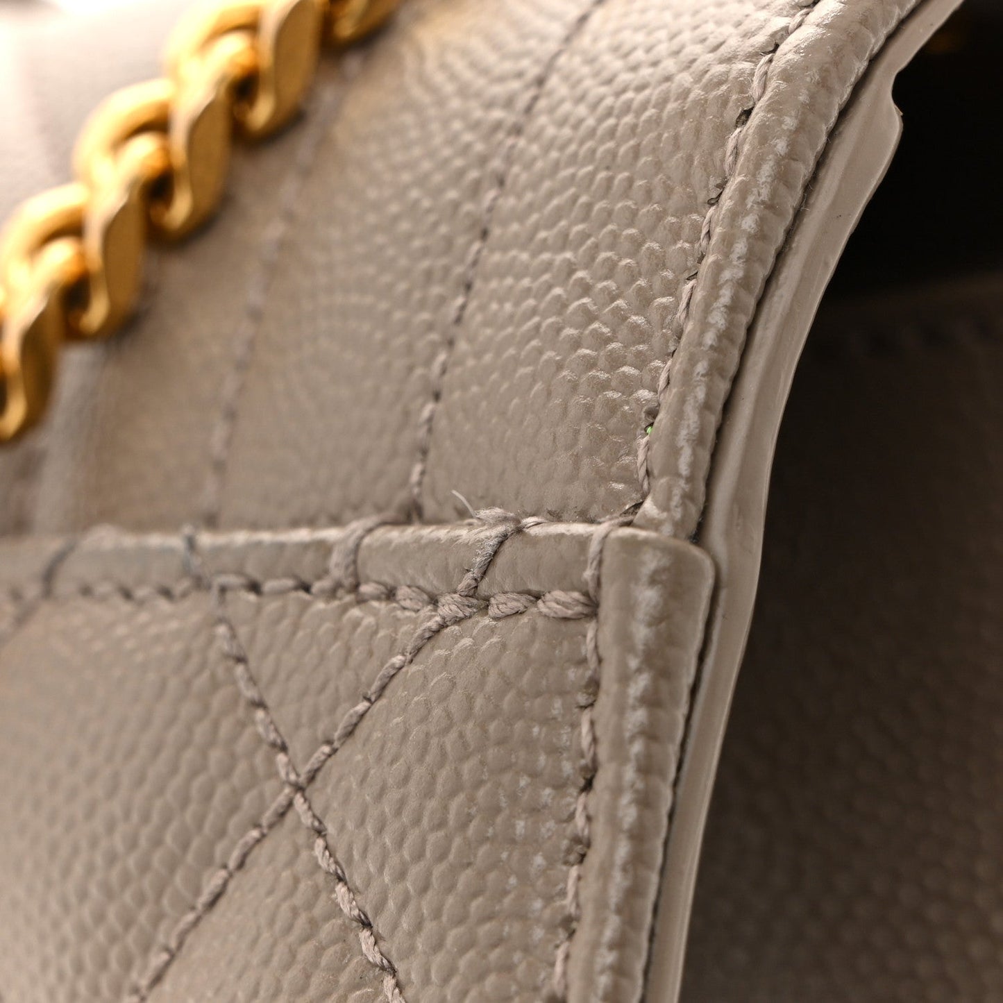 Quilted satchel corner with textured leather and reinforced stitching