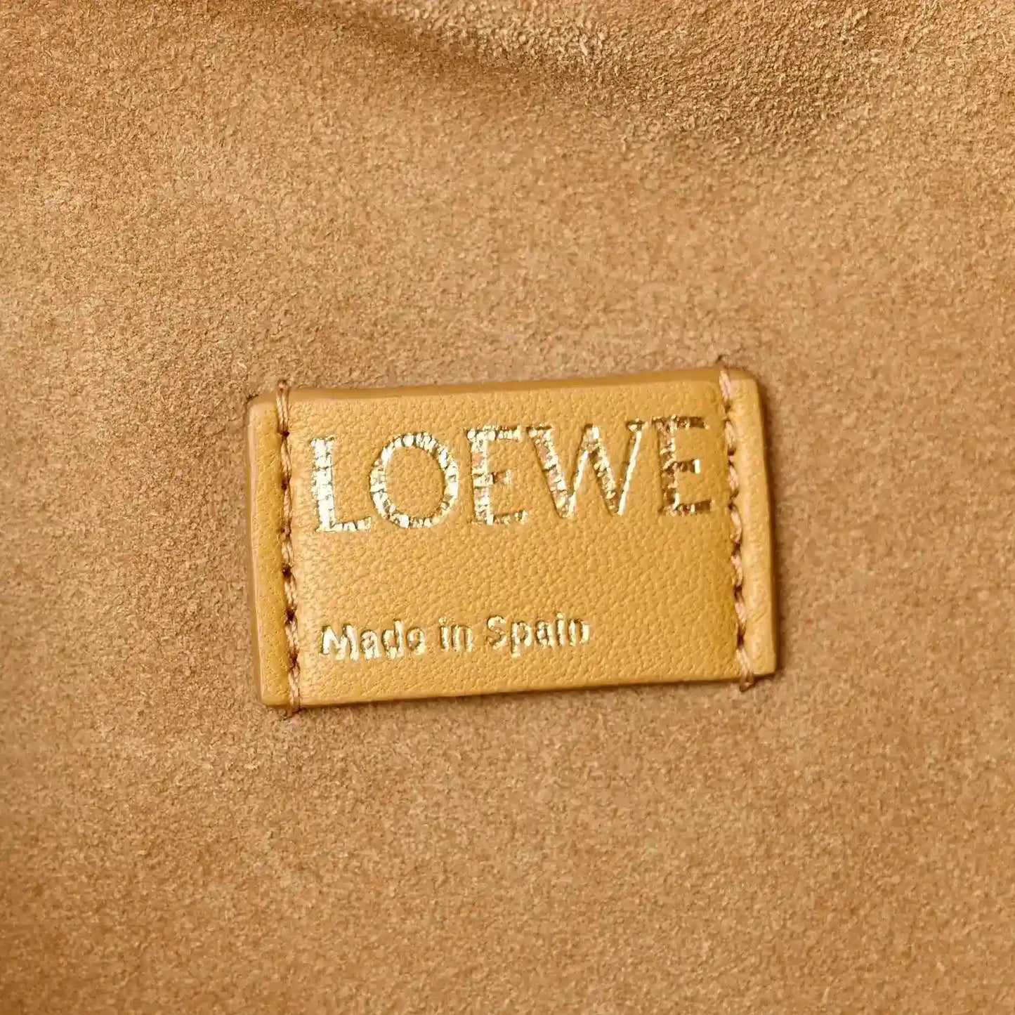 Loewe label on Sahara nappa leather clutch, Made in Spain