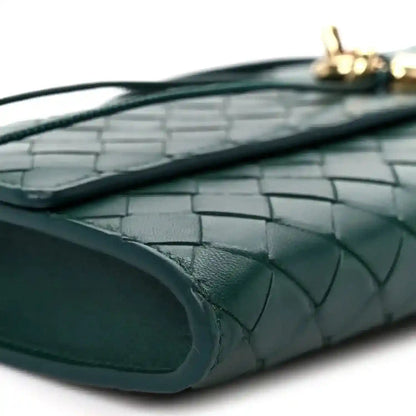 Emerald green intrecciato clutch bag interior pocket with leather weave detail