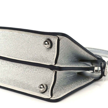 Fendi petite satchel closeup: silver mesh panels, black center seam, stud hardware