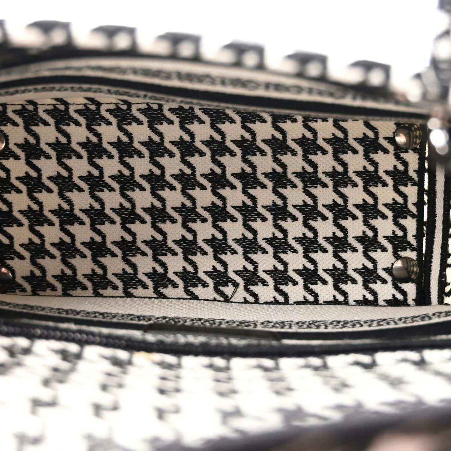 Black-and-white houndstooth canvas bag with black leather edge trim