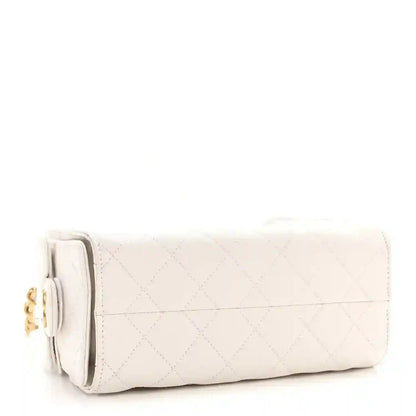 White quilted leather mini handbag with fold-over flap and gold chain strap