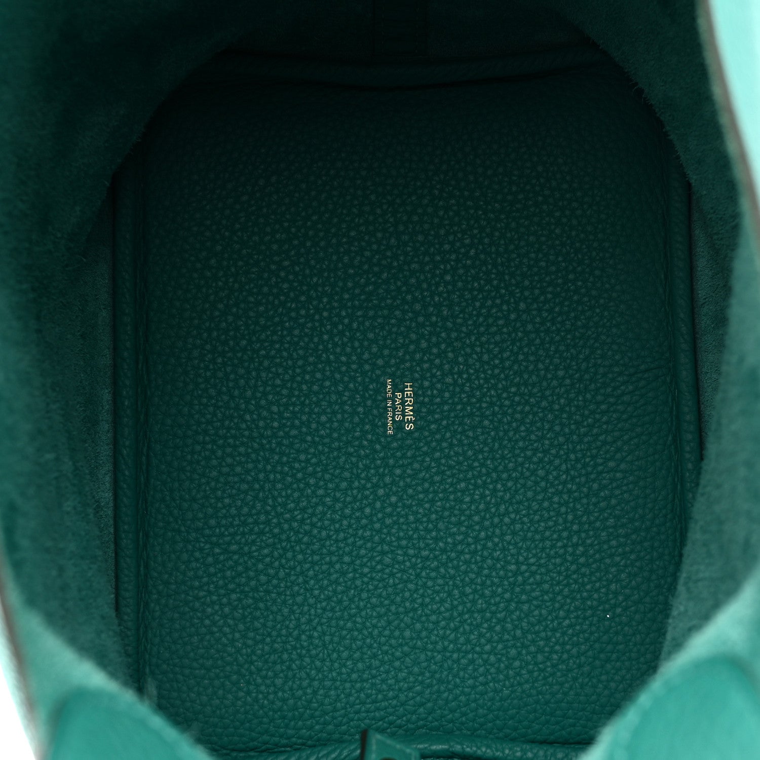 Inside view of green leather lining with brand stamp visible