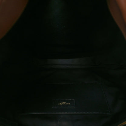 Dark interior lining of leather bag with small fabric logo patch
