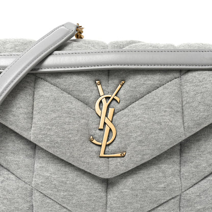 Saint Laurent Loulou puffer satchel flap with gold YSL logo and top handle.