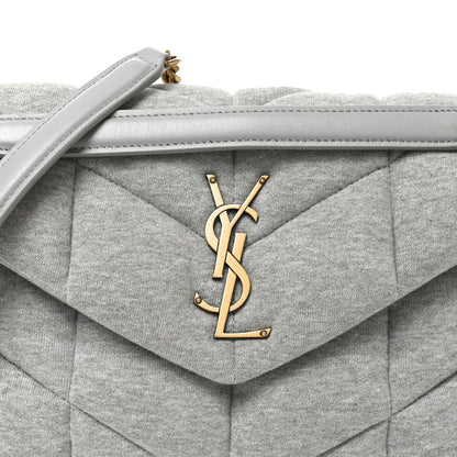Saint Laurent Loulou puffer satchel flap with gold YSL logo and top handle.